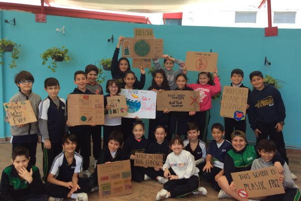 fifth graders showing cardboards about their refuse bottled water campaign 